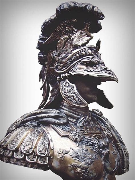 A Close Up Of A Statue Of A Man In Armor With A Helmet And Feathers On