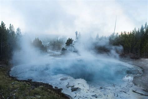 Scenic View Of Steam Emitting From Hot Spring At Yellowstone National