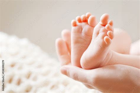 Baby Feet In Mother Hands Tiny Newborn Babys Feet On Female Shaped