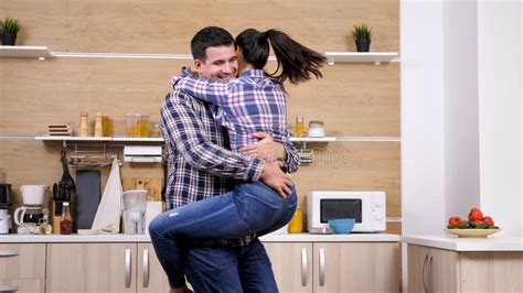 Husband Picking Up Her Beautiful Wife While Dinner Get`s Ready Stock Image Image Of Happiness