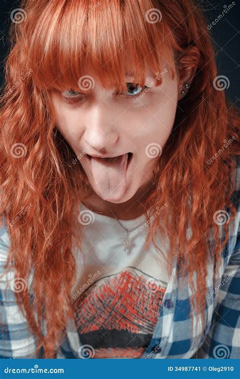 red haired girl shows tongue stock image image of expression feminine 34987741