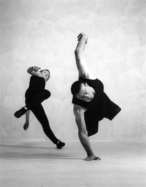 Two People Are Doing An Acrobatic Dance Pose