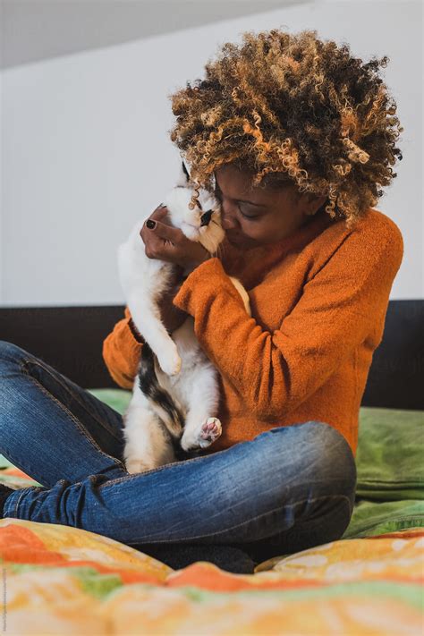 Afro Woman With Her Cat On The Bed By Stocksy Contributor Mauro