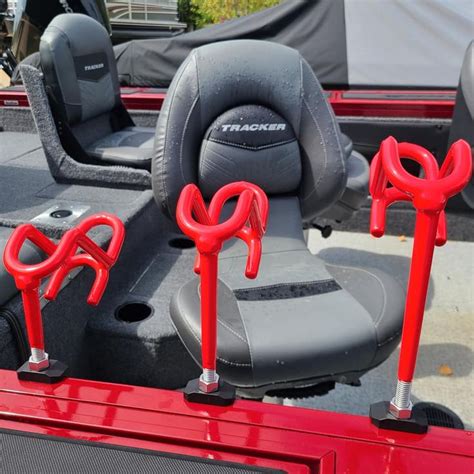 Two Red Seats On The Back Of A Truck With Metal Handles And Hooks