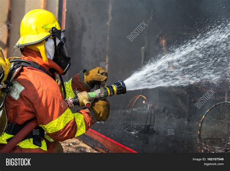 Firefighter Fighting Fire With Hose