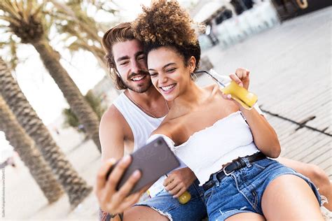 Smiling Couple Making Selfie Outdoors By Stocksy Contributor Guille Faingold Stocksy
