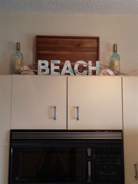 Take a look at these diy countertop ideas for built in cabinets and see if one might work for you. Beach decorating Idea for above the kitchen cabinets ...