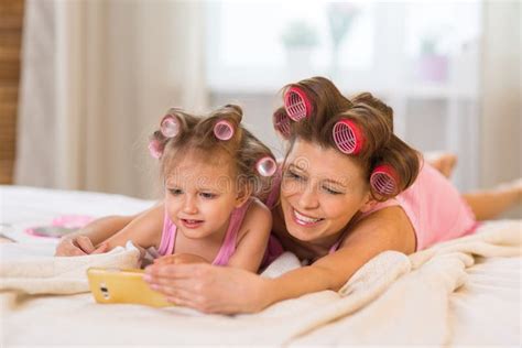 Mom And Daughter In The Bedroom On The Bed In The Curlers Make U Stock Image Image Of Fashion