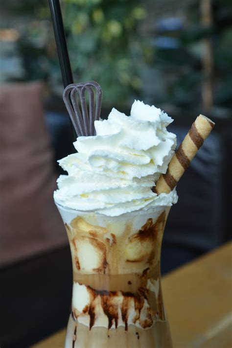 Delicious Iced Coffee With Whipped Cream On A Glass Cup Stock Photo