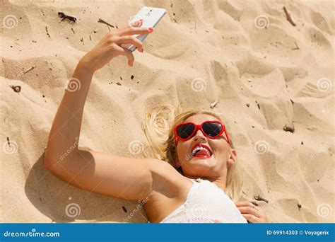 Woman Lying On Sandy Beach Using Cell Phone Stock Image Image Of
