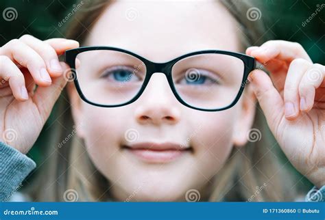 Closeup Portrait Of Little Girl With Myopia Correction Glasses Stock