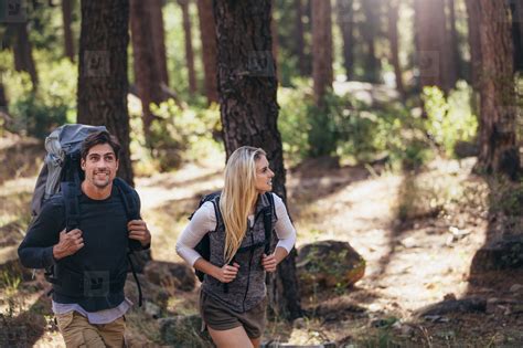 Hiking Couple Walking In Forest Wearing Backpacks Stock Photo 131435