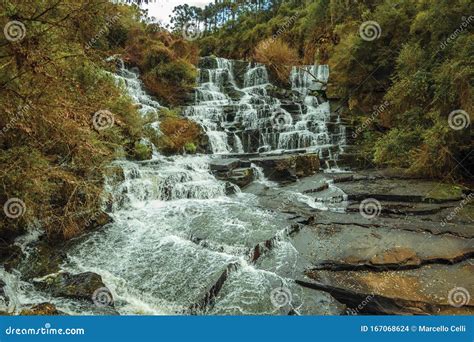 Waterfall Falling Over Rocks In A Lush Forest Stock Photo Image Of