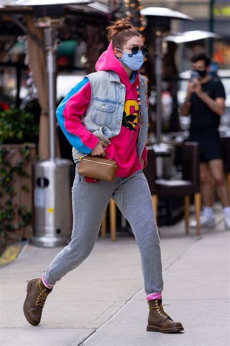 Gigi Hadid Sports A Pink And Blue Hoodie With A Denim Vest And Grey