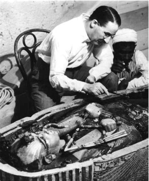 Archaeologist Howard Carter Examining The Opened Sarcophagus Of King