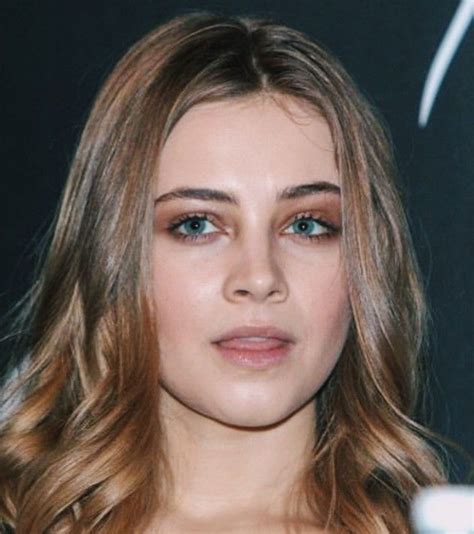 A Close Up Of A Person With Long Hair And Blue Eyes Wearing A Black Dress