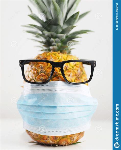 Pineapple Wearing Surgical Mask And Glasses On White Background Stock