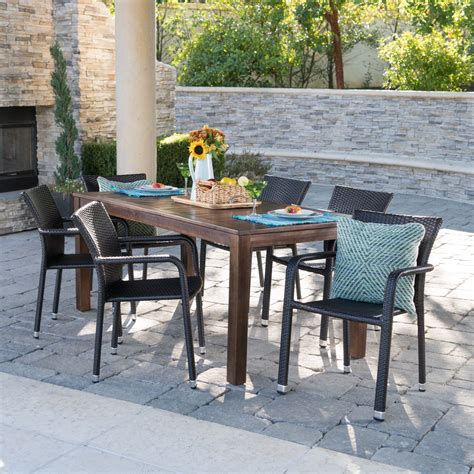 Hassan Outdoor 7 Piece Dining Set with Wood Table and Wicker Dining