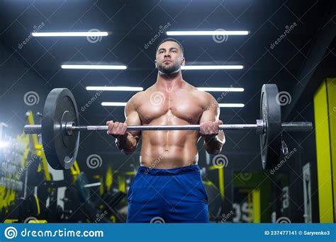 Close Up View Of A Strong Muscular Athlete Lifting Heavy Barbell