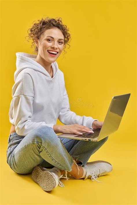 Female Freelancer Working On Laptop While Sitting Crossed Legs On