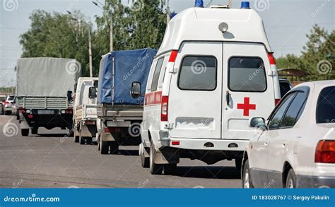 An Ambulance Stands In A Traffic Jam On The Road Heavy Traffic In The