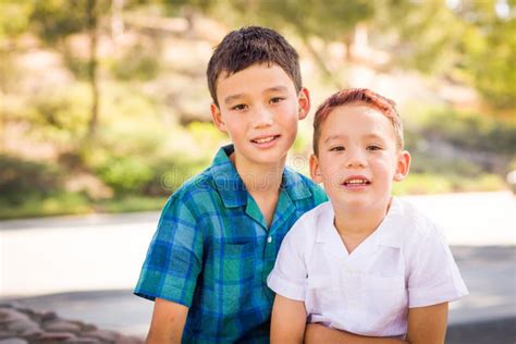 Outdoor Portrait Of Mixed Race Chinese And Caucasian Brothers Stock