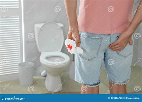 Man Holding Toilet Paper With Blood Stain In Rest Room Hemorrhoid