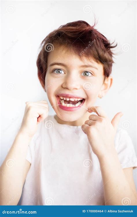 Vertical Portrait Of 7 Years Old Smiling Child In White T Shirt