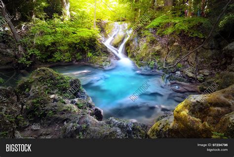 Majestic Nature Background Of Mountain River Stream And Small Blue