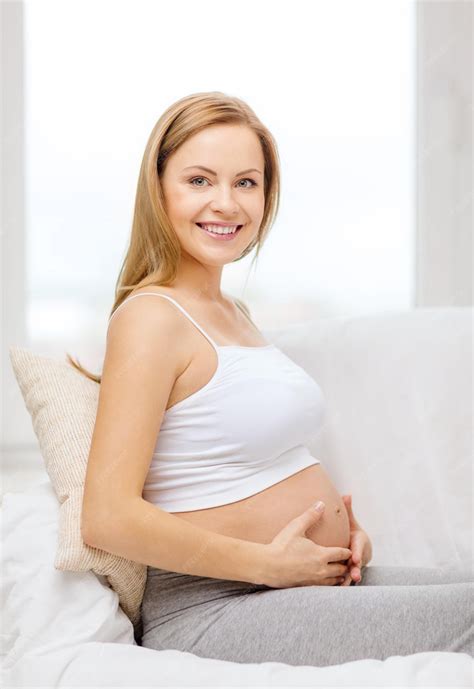 premium photo pregnancy motherhood and happiness concept happy pregnant woman sitting on
