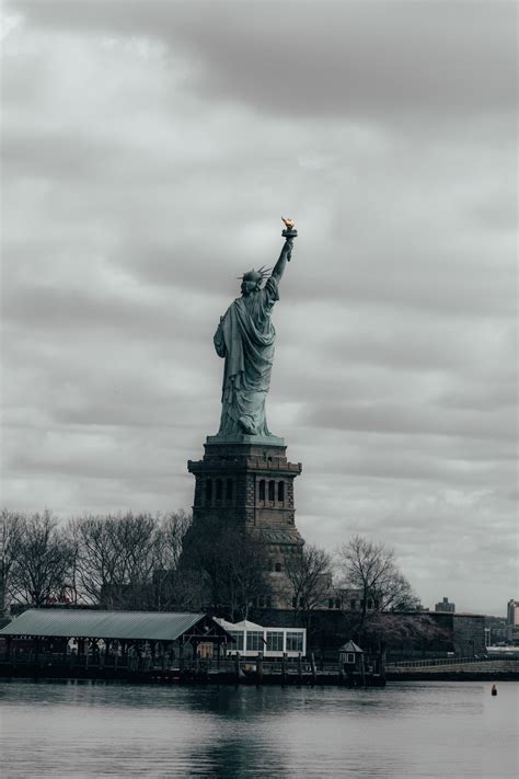 Statue Of Liberty Under Cloudy Sky During Daytime Photo Free Monument