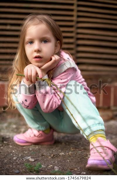 Sitting Girl Squatting Looking Camera Girl Stock Photo 1745679824