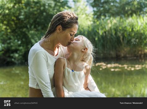 Mother And Daughter Kissing At A Lake Stock Photo Offset