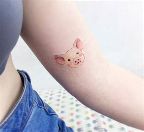 Pig tattoo on the left inner arm.
