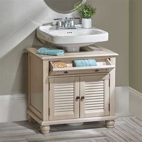 A White Sink Sitting Under A Mirror Next To A Wooden Cabinet With