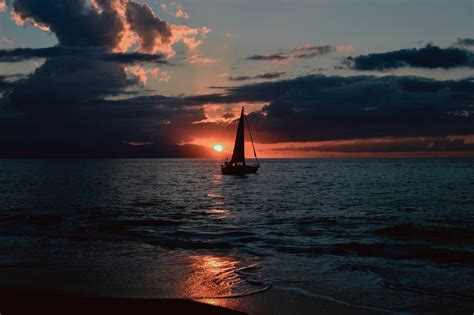 Silhouette Of Sailboat On Body Of Water During Sunset · Free Stock Photo