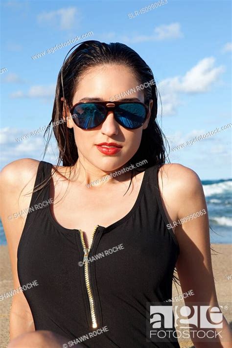 Woman On Beach Wearing Sunglasses Stock Photo Picture And Royalty