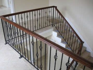 It doesn't have to just be about safety though. dark brown banister with wrought iron balusters | Iron ...