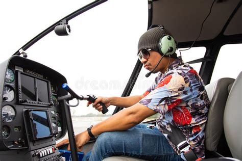 Portrait Of Commercial Pilot In Uniform Sitting Inside Helicopter Cabin