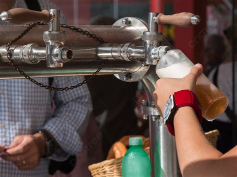 Waitress Hand Pouring A Pint Of Beer From The Tap Photo Background And