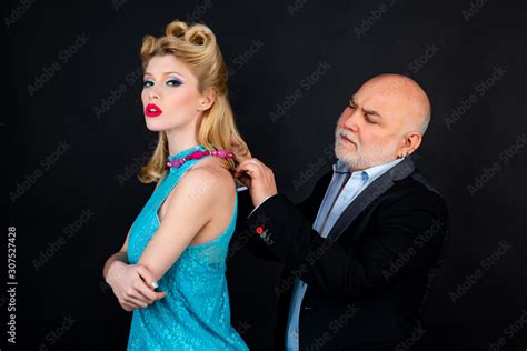 Young Woman With Her Sugar Daddy Concept Capricious Beautiful Blonde Woman In Blue Dress Elder