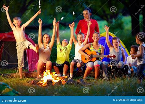 laughing friends having fun around campfire stock images image 37546004