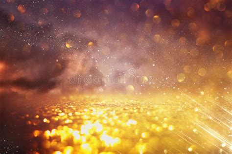 Background Of Abstract Glitter Lights Gold And Black De Focused Stock