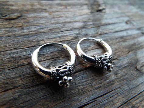 Make a dazzling addition with silver earrings in varied designs. Sterling Silver Bali Hoop Earrings Handmade Jewelry