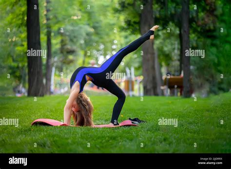 A Little Girl Is Doing Yoga In The Park She Made A Backbend And Stood