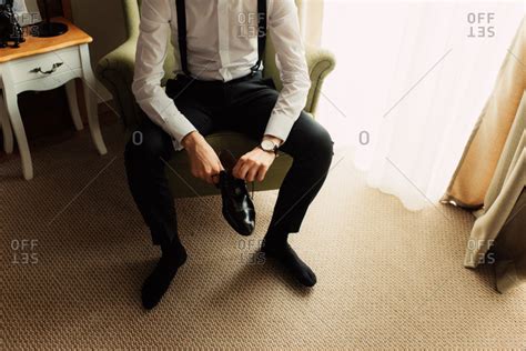 Groom In Chair Putting On Shoes Stock Photo Offset