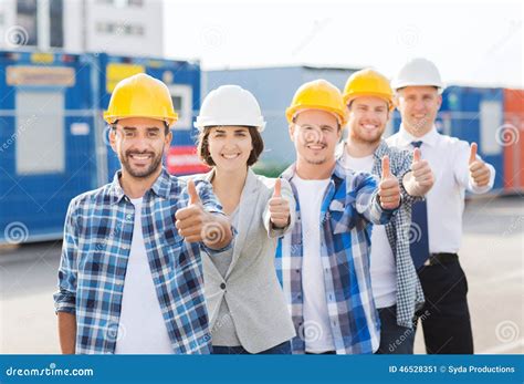 Group Of Smiling Builders In Hardhats Outdoors Stock Image Image Of