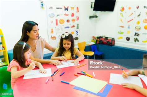Female Preschool Teacher With Her Kids Students Stock Photo Download