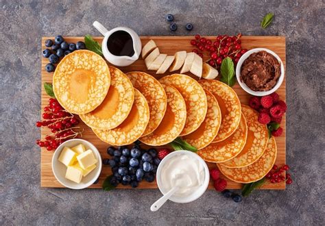 Premium Photo American Pancake Board With Berries Maple Syrup Butter