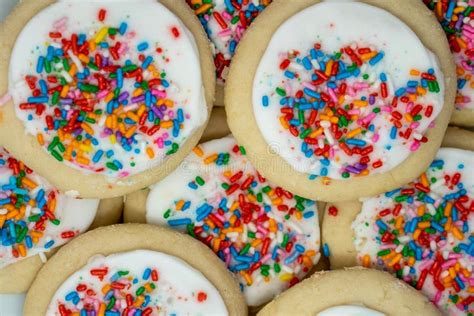 Close Up Macro View Of White Frosted Sugar Cookies With Sprinkles Stock